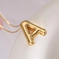 Golden balloon alphabet A pendant necklace with polished metallic finish and link chain - Letter A