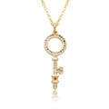 Macro shot of 18k gold heart key pendant with red gemstone and sparkling zircons - Hollow Ring Red Stone Multi-section Key Style (c185)