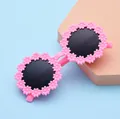 Pink daisy flower sunglasses for kids with round dark lenses and a playful design - Pink