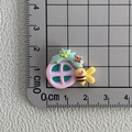 Detailed macro shot of a resin bee and flower charm on a metric scale measuring 2cm - 03*Bee Window