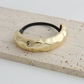 Minimalist hammered gold metal hair tie with fluid texture on cream stone base - Gold Textured Narrow Hair Rope