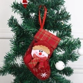Red plaid Christmas stocking with cute snowman doll hanging on a Christmas tree - Red Plaid Snowman Stocking