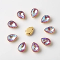 Macro shot of 10x14mm teardrop rhinestones with gold prong settings and sewing holes - 10x14mm / Purple AB