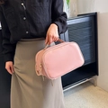 Portable pink makeup bag with gold zipper and top handle in a high-quality leather finish - Pink