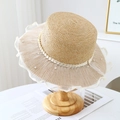 Detail of beige straw boater hat with delicate lace trim and elegant pearl embellishments - Khaki