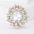 Elegant gold round brooch with a large oval crystal center and sparkling floral petals - Gold