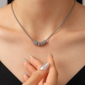 Silver bead chain necklace featuring seven interlocking rings with crystal pavé and polished finish - Stainless Steel Rhinestone Circle Pendant Necklace (G-498)