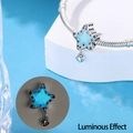 Glow-in-the-dark star charm with blue zircon, showing luminous effect on snake chain - Luminous Starfish