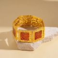 Detail of vintage square gold metal links with red enamel spiral patterns on elastic cord - Red