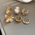 Detail of 6-piece gold ring set featuring baroque pearl, flower design, and hammered metal texture - Gold (6-Piece Set)