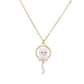 Gold pendant necklace featuring a white enamel cat with blue eyes inside a circular frame - White Enamel Cat