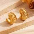Detail of gold C-shaped earrings with celestial sun and moon motifs and cubic zirconia - Star & Moon with Stones
