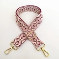 Detail view of red and white jacquard woven guitar strap with gold metal lobster clasps - Fuschia