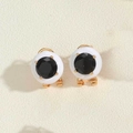 Macro detail of round black rhinestone earrings with white porcelain shell and gold metal - White