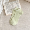 Light green cotton ankle socks with ribbed texture and wavy edges on vintage book background - One Size / Grass Green