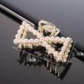 Macro detail of a pearl bow hair claw clip on mirror surface with 5cm size dimensions - Full Pearl Bow 5CM Claw Clip