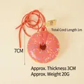 Pink faux donut pendant with colorful sprinkles and 1m long cord hanging toy - Red