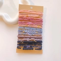 Detail of multi-style gradient hair ties set with gold bead accents on card - Concentric Buckle Korean Color Set