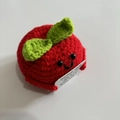Handmade knitted red apple doll with positive card and green leaf on white background - Apple