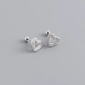 Detailed macro of S925 silver hollow heart earrings with shimmering zircon pavé stones - 925 Silver / White Gold