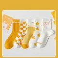 Five-pair pack of yellow and white crew socks featuring checkered patterns and orange prints - Orange Series 5 Pairs Mixed