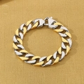 Detailed macro view of two-tone gold and silver Cuban link bracelet with lobster clasp - Two-tone Gold (KB43946-D)