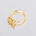 Elegant gold bow ring with sparkling zircons and mirror reflection on grey background - Ring With Zirconia / US 8