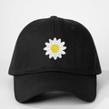 Close-up of daisy embroidery and stitching on a black cotton canvas baseball cap - One Size / Black