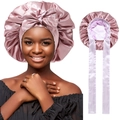 Close-up of pink satin sleep bonnet featuring a bow knot and long ribbon ties - Bow Decoration / Pink/Light Purple