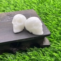 Pair of 2.8cm white natural stone hand-carved crystal skulls on a wooden display base - White Jade