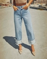 Detail of high-waist light blue stretch denim jeans featuring wide folded cuffs and vintage wash - S / Light Blue