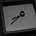Macro shot of black titanium steel ear cuff with chain and rectangular pendant - Clip Bar + Chain (Non-Pierced) / Black