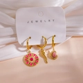 Detailed view of three 14K gold earrings with pink enamel and natural stone pendants - Pink Enamel Horn Gemstone Style (Card G) / 3 Piece Set