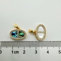 Macro detail of pig nose shaped pendants with shell inlays and zircon edges on ruler - Pig Snout (abalone Shellfish)
