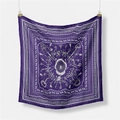 Macro detail of silk square scarf featuring retro key motifs and ornate patterns - Purple