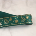 Macro detail of green ribbed Christmas ribbon with gold foiled Christmas trees and snowflakes - 2.5cm Gold Rim Christmas Green (22 Meters)