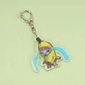 Acrylic crying banana cat keychain with silver metal clip on a light green background - Crying Style