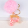 Pink fur pompom keychain with gold letter P charm featuring resin and gold leaf details - Letter P