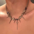 Close-up of punk style necklace with silver spikes, purple beads and a cross pendant - Silver with Purple Cross Spike