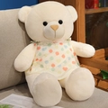 Cream teddy bear plush in a polka dot heart dress sitting on a cozy fabric sofa - 80cm(1kg) / White