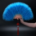 Detailed view of large blue feather dance fan with bamboo ribs and red tassel decoration - Lake Blue