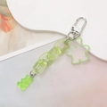 Detail of light green transparent bear keychain with acrylic chain and glitter finish - Green
