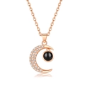 Rose gold moon necklace featuring micro-pave crystals and a black projection stone - Moon Rose Gold