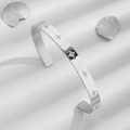 Polished silver C-shaped stainless steel cuff bracelet with sparkling star-shaped engravings - Silver