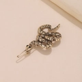 Fermaglio per capelli a forma di serpente in metallo bronzo antico su sfondo beige - Oro Antico