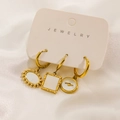 Macro detail of three 14K gold-plated earrings with shell pendants on jewelry card - Lightning Mother of Pearl Geometric Style (E Card)