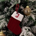 Red knit Christmas stocking with embroidered letter J and festive santa hat detail - Style J