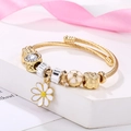 Golden open bangle with sunflower enamel pendant and sparkling rhinestone charms - White Daisy