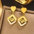 Detailed close-up of 18K gold earrings with shell inlay and heart-shaped pendant design - Gold E-403 (Rhombus ECG Heart)