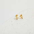 Gold Sagittarius archer arrow stud earrings with colorful gemstones on white stone - Arrow